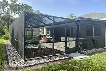 Gable screen enclosure with insulated patio cover roof